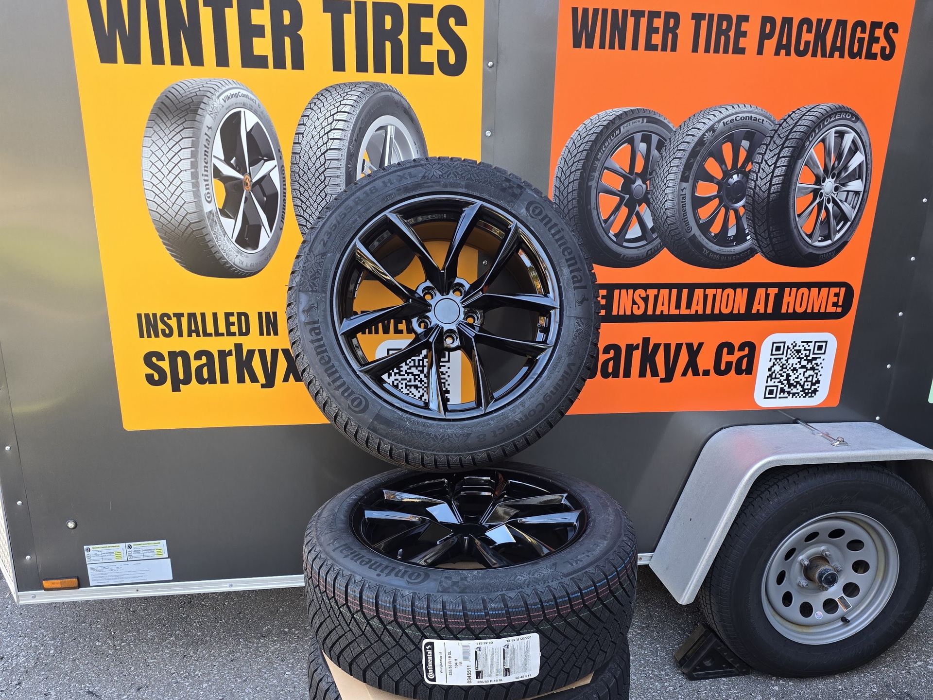 Winter tire and wheel package beside the Sparky X mobile service trailer at a GTA job site